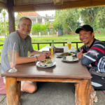 Guest enjoying a cycling tour in Ubud through rice fields with a friendly local guide family cycling in ubud rice field kids cycling in ubud village